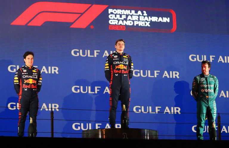 BAHRAIN, BAHRAIN - MARCH 05: Race winner Max Verstappen of the Netherlands and Oracle Red Bull Racing (C), Second placed Sergio Perez of Mexico and Oracle Red Bull Racing (L) and Third placed Fernando Alonso of Spain and Aston Martin F1 Team (R) stand on the podium during the F1 Grand Prix of Bahrain at Bahrain International Circuit on March 05, 2023 in Bahrain, Bahrain. (Photo by Peter Fox/Getty Images)