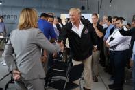 <p>President Donald Trump shakes hands with San Juan Mayor Carmen Yulin Cruz during a briefing on hurricane recovery efforts with first responders at Luis Muniz Air National Guard Base, Tuesday, Oct. 3, 2017, in San Juan, Puerto Rico. (Photo: Evan Vucci/AP) </p>