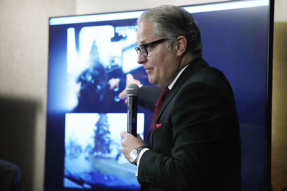 Attorney Ven Johnson points out details in body cam footage after announcing the filing of a civil lawsuit on behalf of Patrick Lyoya's family, Wednesday, Dec. 7, 2022, in Detroit. (AP Photo/Carlos Osorio)