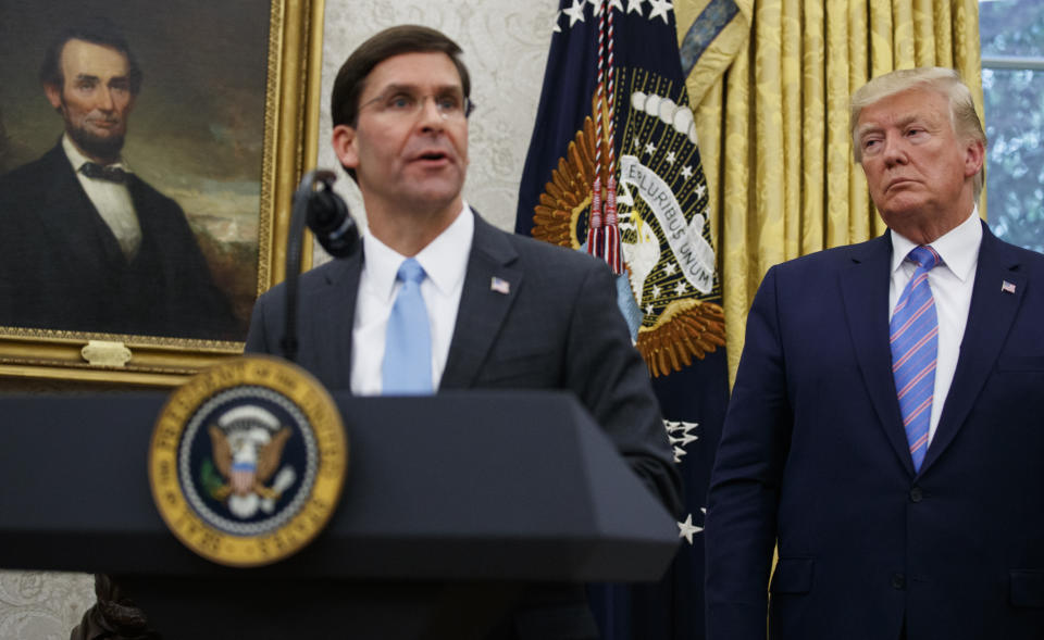 President Donald Trump looks to Secretary of Defense Mark Esper during a ceremony in the Oval Office at the White House in Washington, Tuesday, July 23, 2019. (AP Photo/Carolyn Kaster)