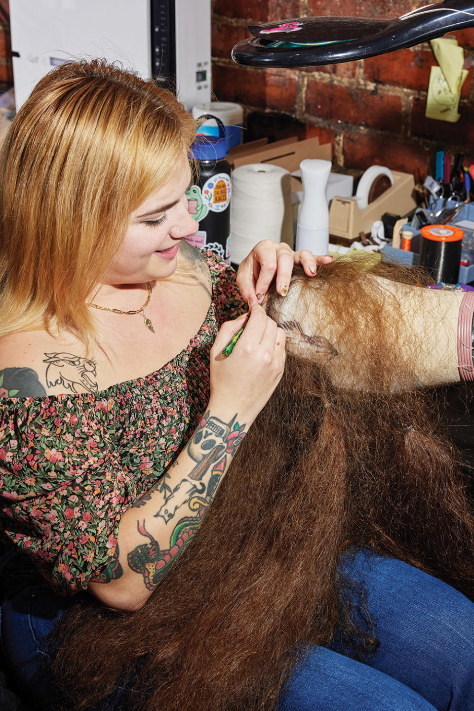 Kelso Millett hand-ties knots to create a custom wig. According to Pickens, wig consultations can sometimes stretch on for months with input from filmmakers, showrunners, and costume and hair department leads.