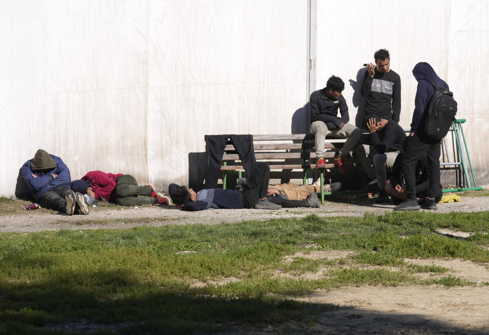 A group of migrants rest at reception camp near the southern border with North Macedonia, in Presevo, Serbia, Wednesday, Oct. 19, 2022. Located at the heart of the so-called Balkan route, Serbia recently has seen a sharp rise in arrivals of migrants passing through the country in search of a better future in the West. (AP Photo/Darko Vojinovic)