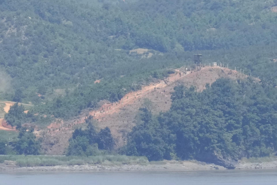 North Korean along the military fences near a military guard post, top right, are seen from South Korea's Paju, South Korea, Tuesday, June 4, 2024. South Korea’s government has approved the suspension of a contentious military agreement with North Korea, a step that would allow it to take tougher responses to North Korean provocations. (AP Photo/Lee Jin-man)