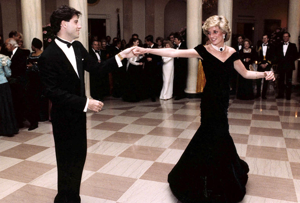 <p>So Diana and Travolta weren’t really friends, but they did share an iconic moment, on the evening of Nov. 9, 1985, when both were guests at a White House dinner <span>— </span>and not by accident. <i>People</i> reported at the time that Travolta had been invited as part of <a rel="nofollow noopener" href="http://people.com/archive/princess-diana-vol-24-no-26/" target="_blank" data-ylk="slk:first lady Nancy Reagan’s plan;elm:context_link;itc:0;sec:content-canvas" class="link ">first lady Nancy Reagan’s plan</a> to show the royal a good time. “When the music from your movie comes up, if you wouldn’t mind just asking her if she’d care to dance,'” Travolta recalled FLOTUS asking him. He did and they did “spins and turns” and what he called a “modern fox-trot” to “You Should Be Dancing” and “Disco Inferno.” Is there anything more ’80s than that? (Photo: Ronald Reagan Library/AP) </p>