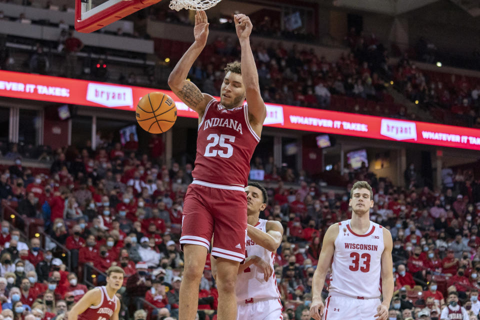 Indiana's Race Thompson (25) dunks past Wisconsin's Johnny Davis (1) and Chris Vogt during the first half of an NCAA college basketball game Wednesday, Dec. 8, 2021, in Madison, Wis. (AP Photo/Andy Manis)