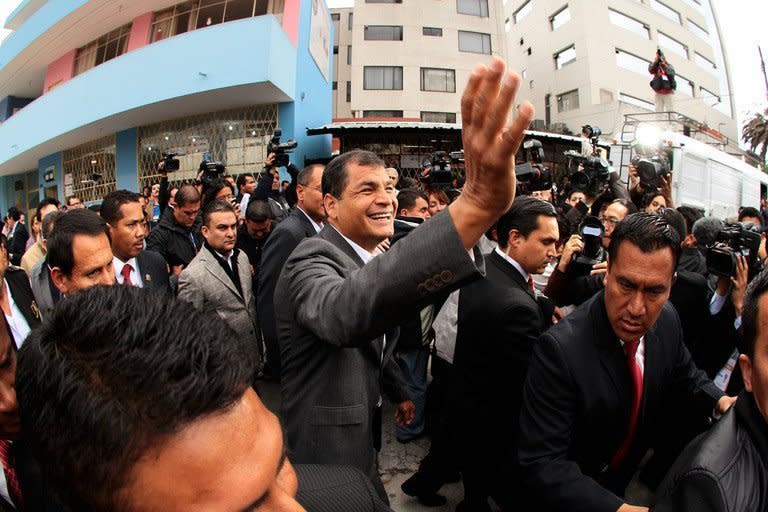 Ecuadorean President Rafael Correa (C) waves after voting a polling station in Quito on February 17, 2013. Correa declared victory in the first-round of Ecuador's presidential vote Sunday as he celebrated with thousands of supporters in the capital of the South American country