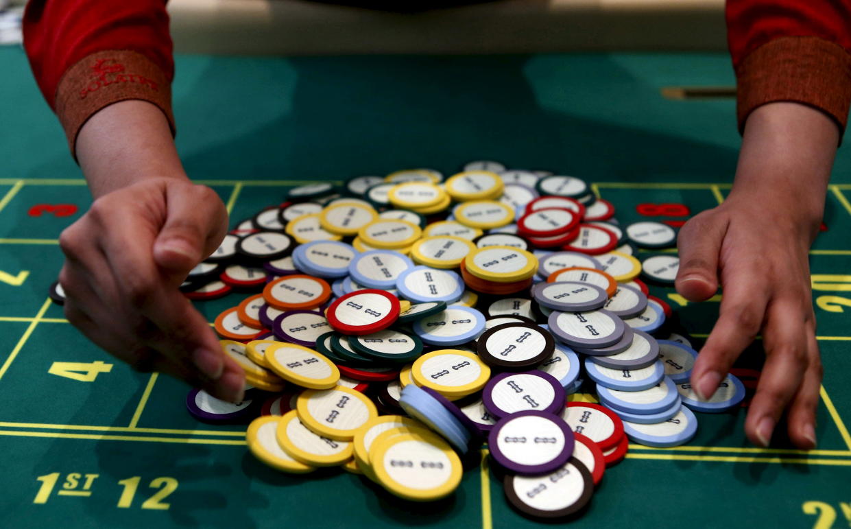 A casino dealer collects chips at a roulette table inside Solaire Casino in Pasay city, Metro Manila, Philippines, March 27, 2015. The Philippines has emerged as one of Asia's hottest gambling hubs after it launched its 120-hectare (1.2 square km) gaming and leisure enclave called Entertainment City in the capital, modelled on the Las Vegas strip. When paying your final respects for a relative or friend, the last thing you might expect to see at the wake is people placing bets on a card game or bingo. Not in the Philippines. Filipinos, like many Asians, love their gambling. But making wagers on games such as 