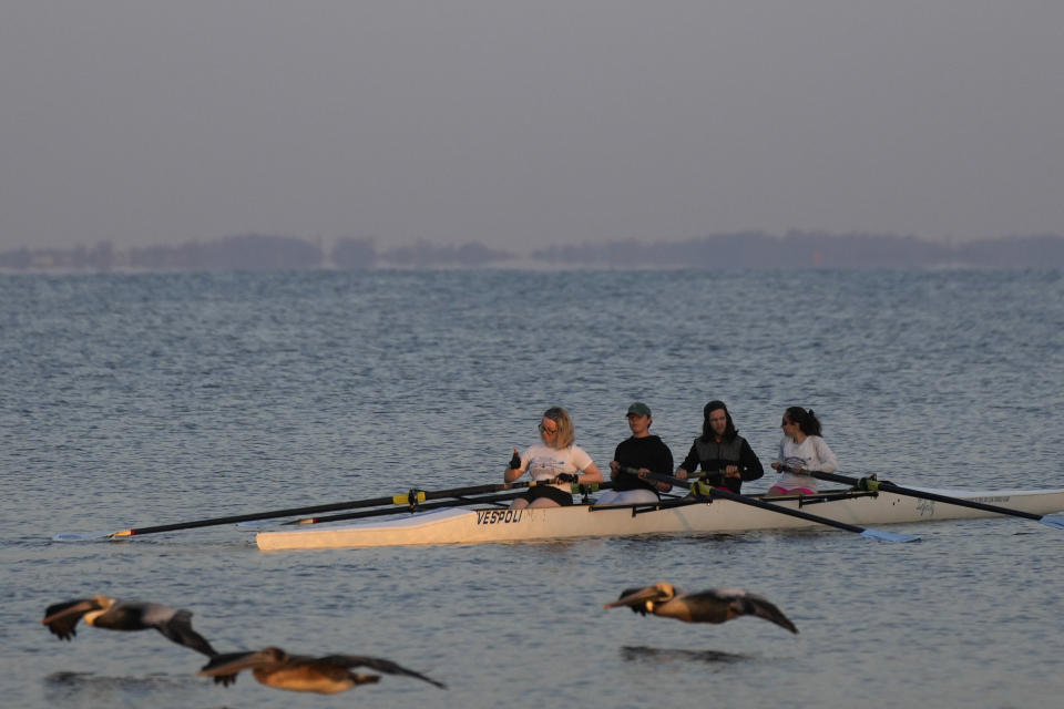 Members of the recently formed crew team at New College of Florida head out from shore as they begin a morning practice session, Thursday, March 2, 2023, in Sarasota, Fla. Students and faculty compare the upheaval at New College to a "hostile takeover" that feels even more jarring because of what the school has represented to so many students for so many years: a haven of open-mindedness and acceptance in a place of idyllic beauty, with palm-tree-lined paths along a stretch of white-sand coast. (AP Photo/Rebecca Blackwell)