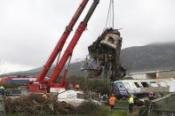 Cranes remove debris after a trains' collision in Tempe, about 376 kilometres (235 miles) north of Athens, near Larissa city, Greece, Thursday, March 2, 2023. Rescuers using cranes and heavy machinery on Thursday searched the wreckage of trains involved in a deadly collision that sent Greece into national mourning and prompted strikes and protests over rail safety. (AP Photo/Vaggelis Kousioras)