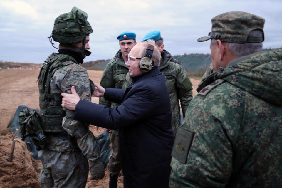 Vladimir Putin speaks to a soldier while visiting a military training center of the Western Military District in the Ryazan region of Russia (AP)