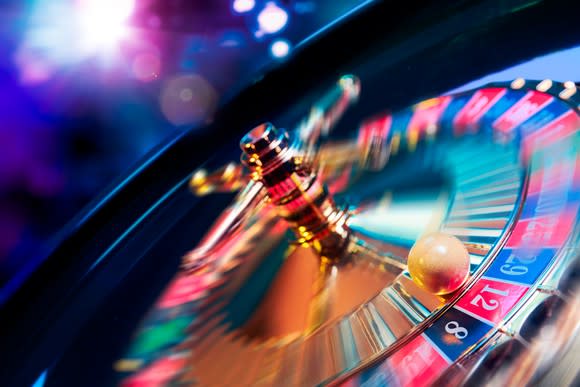 A close-up of a spinning roulette wheel and roulette ball.