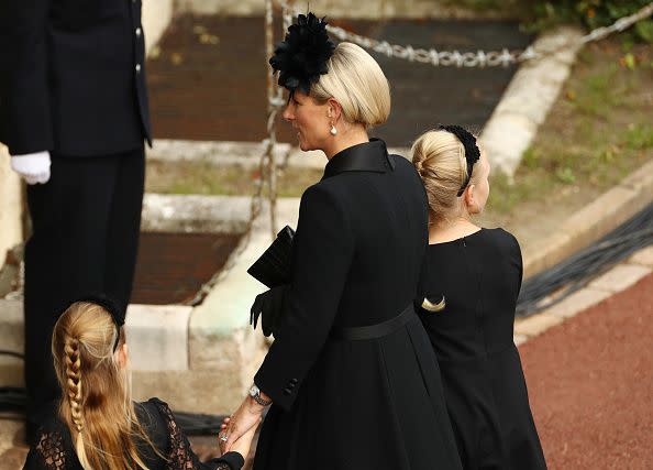 WINDSOR, ENGLAND - SEPTEMBER 19: Zara Tindall, Lena Tindall, and Mia Tindall arrive at Windsor Castle for the Committal Service for Queen Elizabeth IIon September 19, 2022 in Windsor, England. The committal service at St George's Chapel, Windsor Castle, took place following the state funeral at Westminster Abbey. A private burial in The King George VI Memorial Chapel followed. Queen Elizabeth II died at Balmoral Castle in Scotland on September 8, 2022, and is succeeded by her eldest son, King Charles III. (Photo by Ryan Pierse/Getty Images)