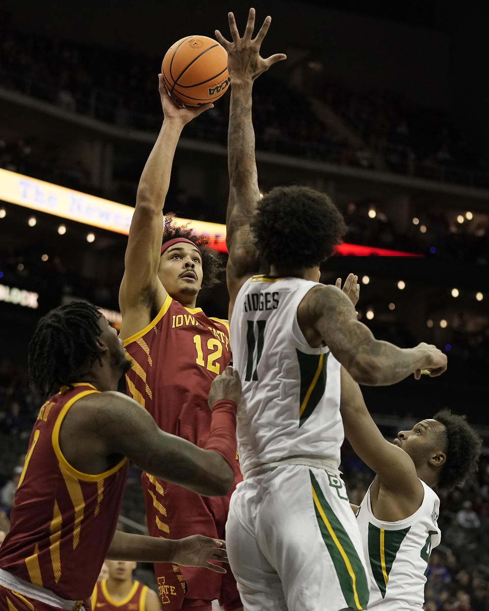 Iowa State forward Robert Jones (12) shoots under pressure from Baylor forward Jalen Bridges (11) during the first half of an NCAA college basketball game in the second round of the Big 12 Conference tournament Thursday, March 9, 2023, in Kansas City, Mo. (AP Photo/Charlie Riedel)