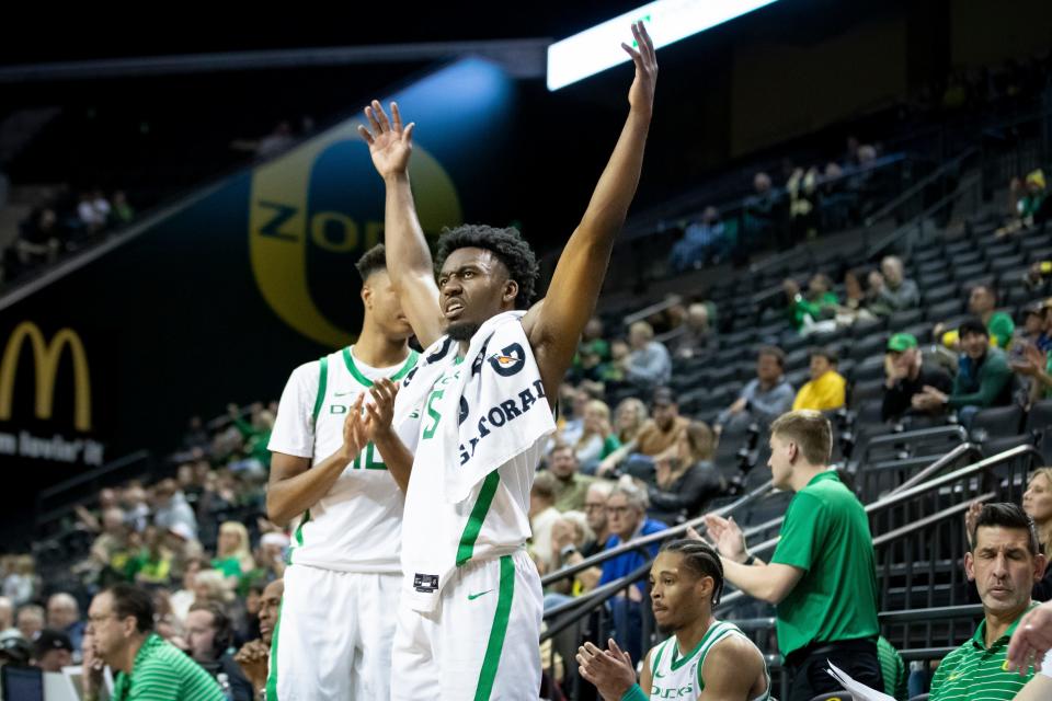 Oregon guard Jermaine Couisnard cheers from the bench as the clock winds down as the Oregon Ducks host California Baptist Dec. 12, 2023, at Matthew Knight Arena in Eugene.