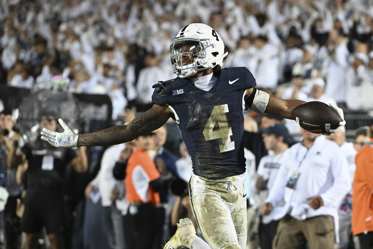 Penn State cornerback A.J. Harris (4) celebrates an interception against Illinois during the fourth quarter of an NCAA college football game, Saturday, Sept. 28, 2024, in State College, Pa. (AP Photo/Barry Reeger)