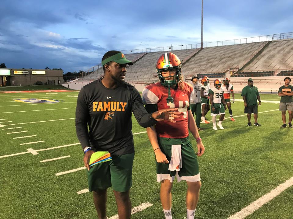 FAMU quarterback Ryan Stanley listens attentively to co-offensive coordinator/QB coach KJ Black during practice in 2019.