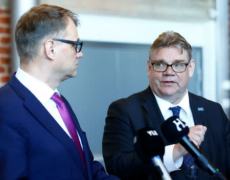 Finland's Prime Minister Juha Sipila (L) listens to Foreign Minister Timo Soini after government's open session for members of public took place during the celebration of the 100th anniversary of Finnish independence in Porvoo, Finland May 4, 2017. REUTERS/Ints Kalnins