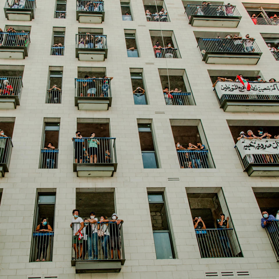 People gather on balconies during the demonstration. Protesters say negligence and corruption across Lebanon's political system contributed to the disaster. | Myriam Boulos for TIME