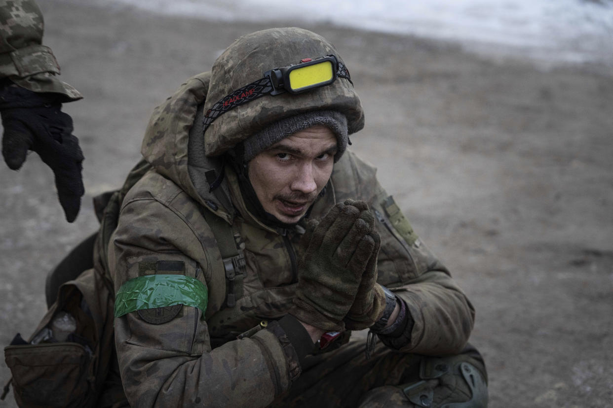 A Ukrainian military medic sits on the ground as he is evacuated with his injured comrades from the battlefield into a hospital in Donetsk region, Ukraine, Monday, Jan. 9, 2023. (AP Photo/Evgeniy Maloletka)