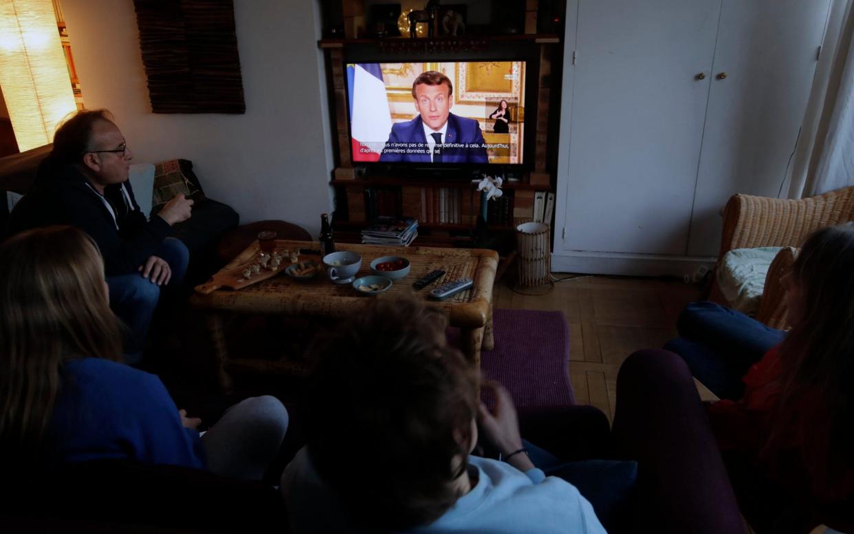 The Fonsino family watch Emmanuel Macron's speech on Sunday night in Ville d'Avray, near Paris - Christophe Ena/AP