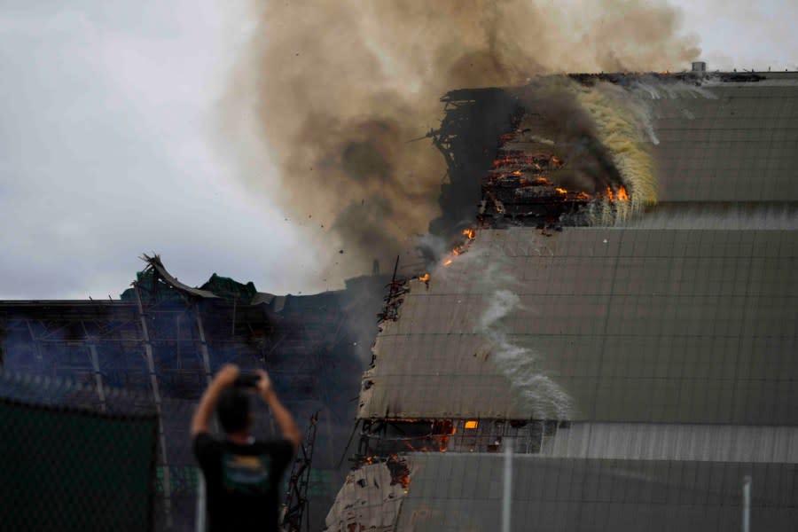 A historic blimp hangar burns in Tustin, Calif., Tuesday, Nov. 7, 2023. A fire destroyed a massive World War II-era wooden hangar that was built to house military blimps based in Southern California. (AP Photo/Jae C. Hong)