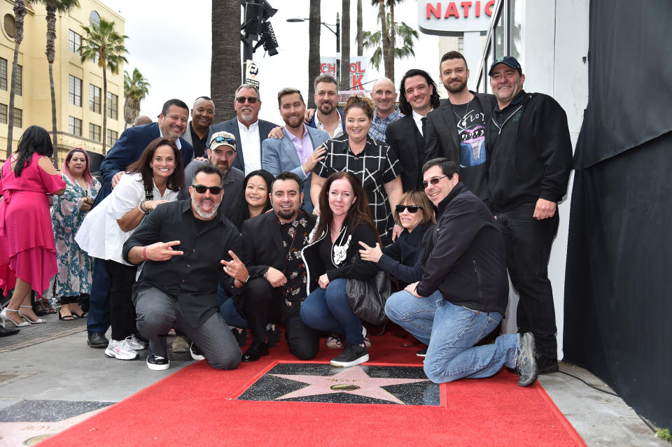 The entire group posing with their families, and smiling like they Just Got Paid.