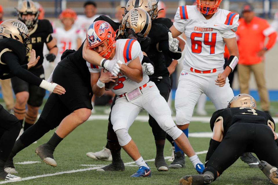 RiderÕs Luke Gambs (15) tackles Canutillo quarterback Devin Granados as he runs on a keeper November 26, 2021 at Grande Communications Stadium in Midland.