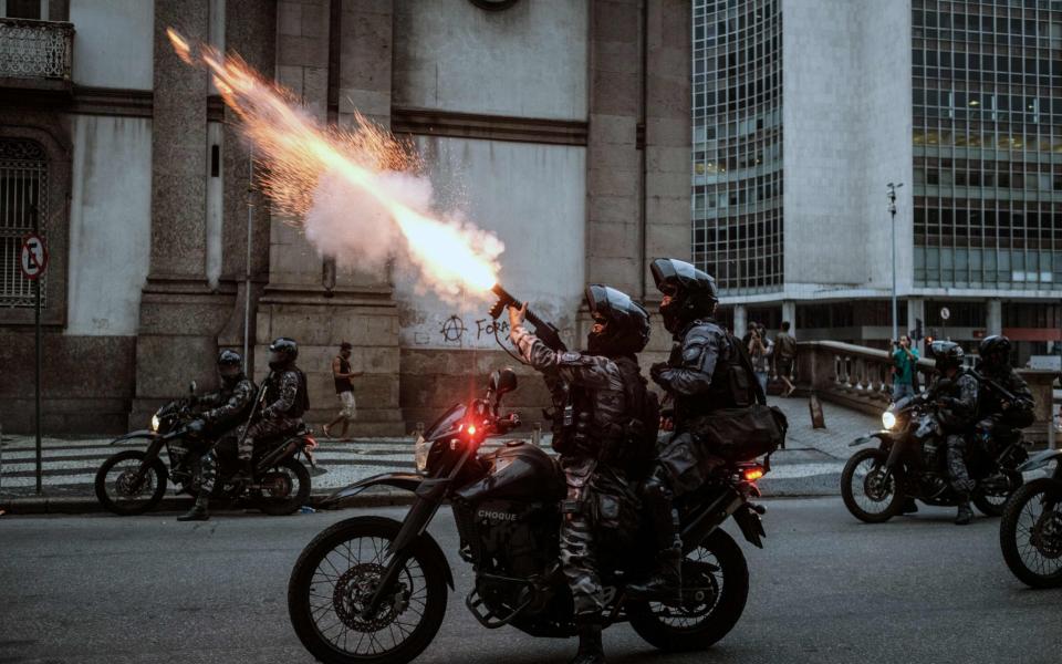 The military police shoot against protesters during the nationwide strike called by unions opposing austerity reforms in Rio de Janeiro, Brazil - Credit: AFP