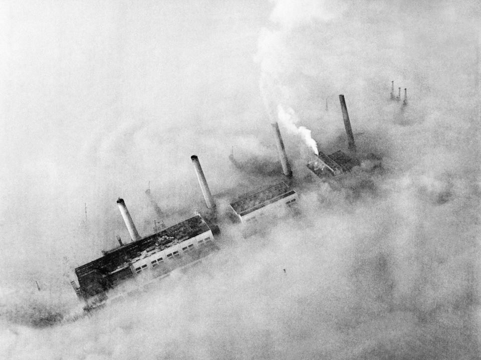 Chimneys of an East End factory poke through the blanket of smog covering London.