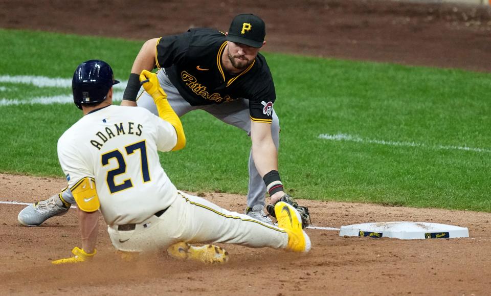 Brewers shortstop Willy Adames is tagged out by Pirates second base Jared Triolo while trying to stretch his two-run double in the seventh inning.