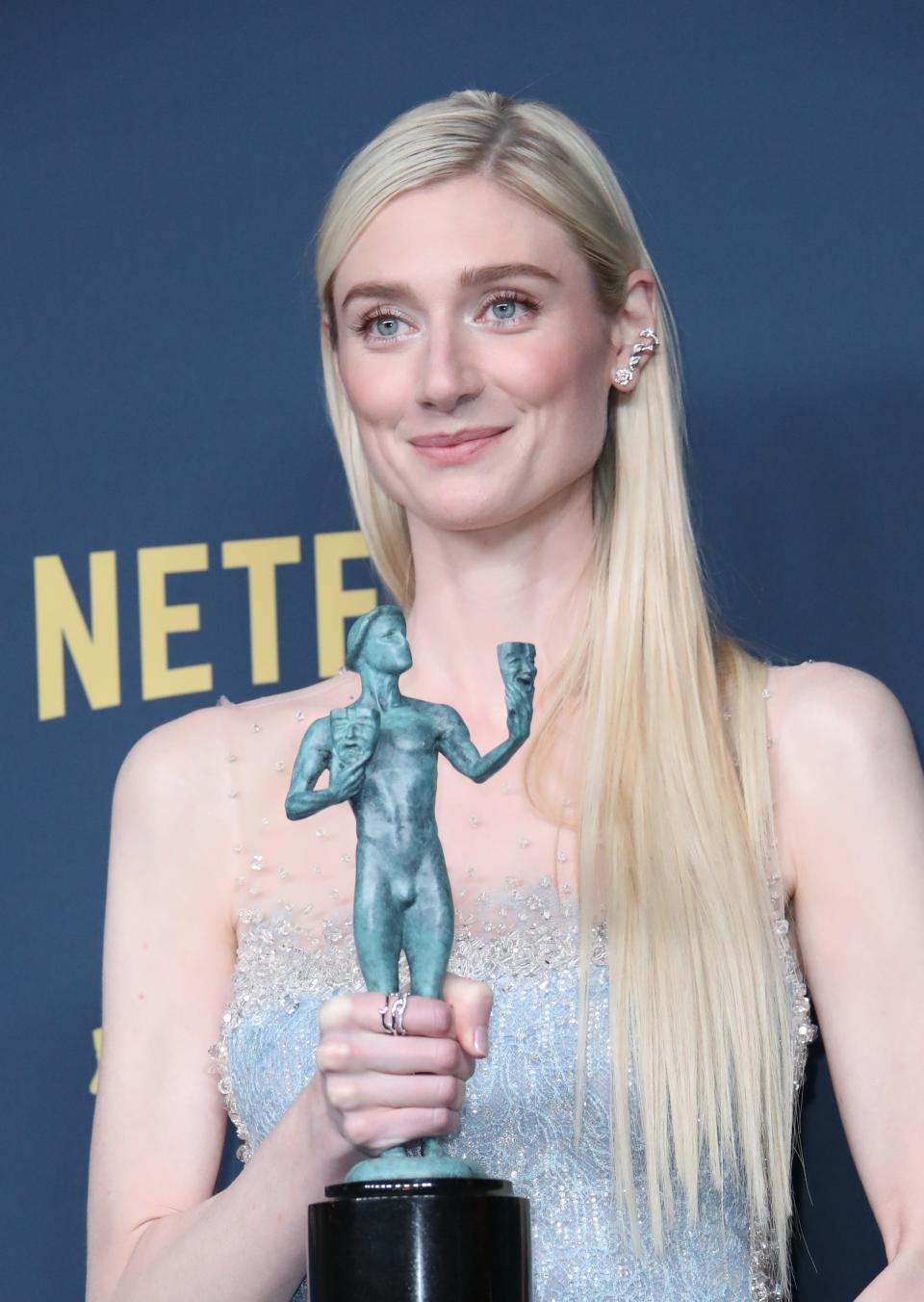 "The Crown" actress Elizabeth Debicki proudly holds her statuette for lead actress in a drama series.