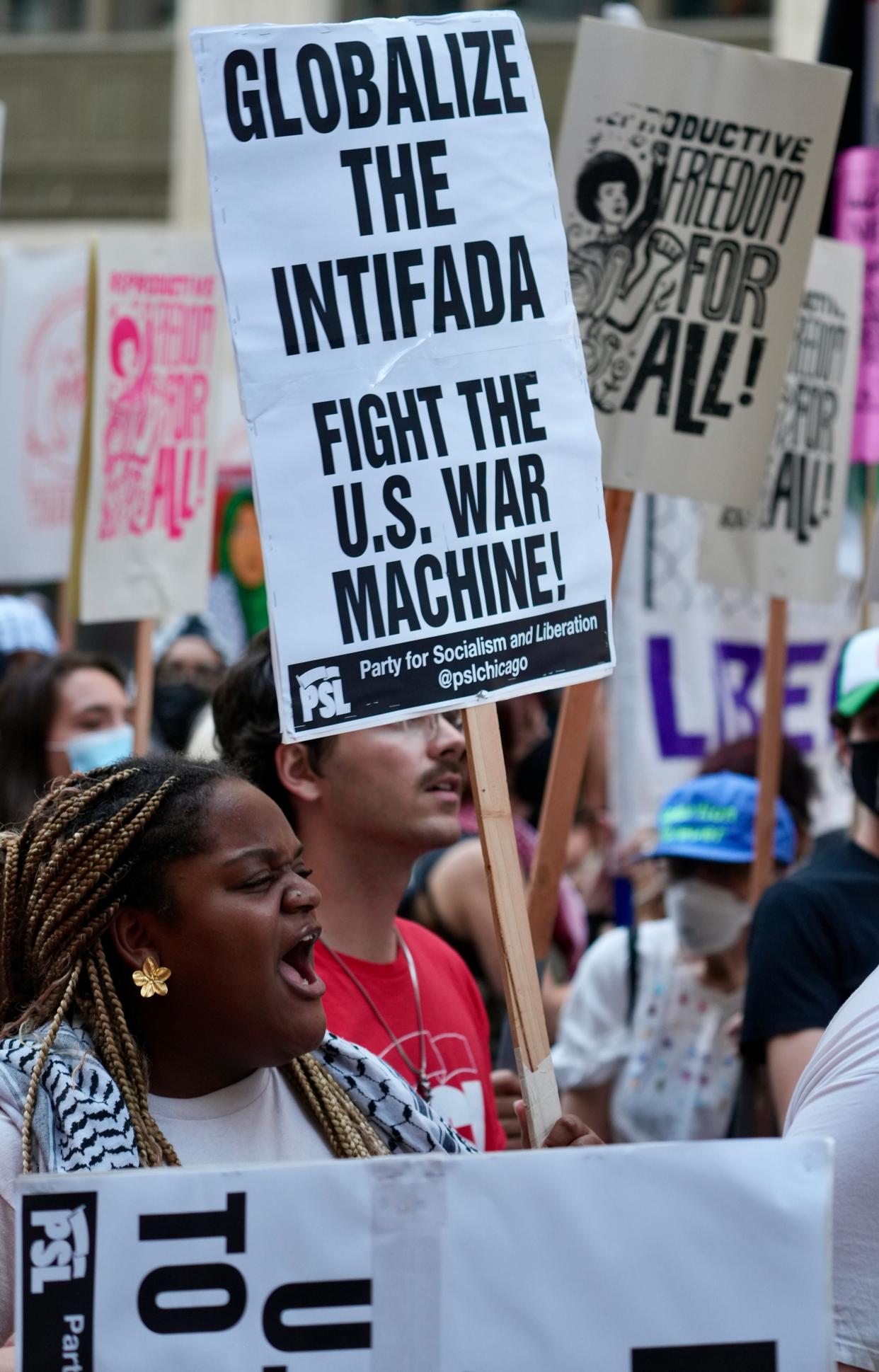 Marchers at a Sunday evening protest to support Gaza, reproductive rights and the LGBT community walk down Michigan Avenue in Chicago prior to be official start of the Democratic National Convention on Monday.