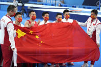 China's artistic gymnastics men's team, Lin Chaopan, Sun Wei, Xiao Ruoteng and Zou Jingyuan celebrate after winning the bronze medal at the 2020 Summer Olympics, Monday, July 26, 2021, in Tokyo. (AP Photo/Natacha Pisarenko)