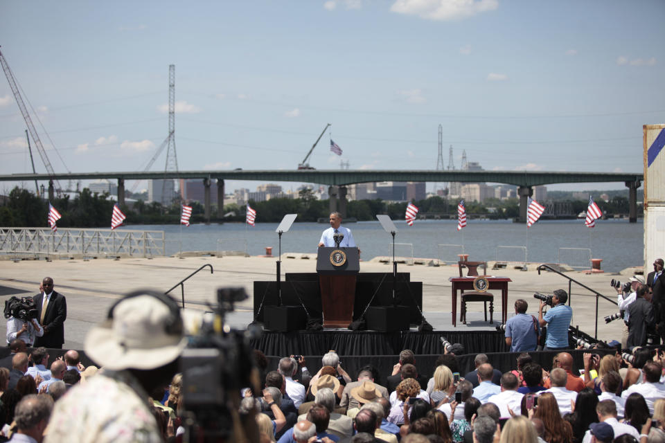 President Barack Obama announces new national infrastructure initiative at the Port of Wilmington, Delaware, in front of the I-495 Bridge, which was undergoing substantial structural repairs, on July 17, 2014. The new initiative at the U.S. Department of Transportation sought to encourage private investment in infrastructure projects such as repairing roads and bridges.