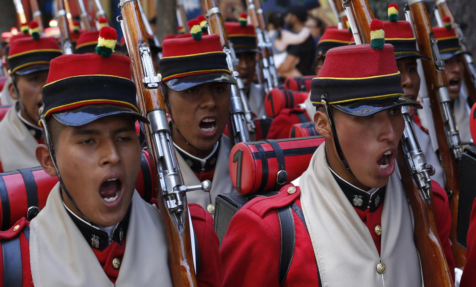 In this March 23, 2019 photo, Bolivia's "Batallon Colorados," sing the national anthem during an event honoring national hero Eduardo Abaroa, who died in the 1879-1883 War of the Pacific, as part of Sea Day celebrations in La Paz, Bolivia. Bolivians are marking the first Day of the Sea after the International Court of Justice in The Hague in October 2018 rejected a bid by Bolivia to force Chile to negotiate access to the Pacific Ocean. Bolivia lost its route to the sea in a war with Chile. (AP Photo/Juan Karita)