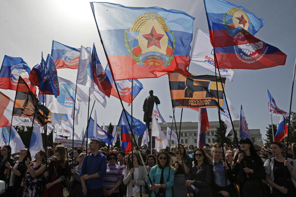 People waving flags at rally