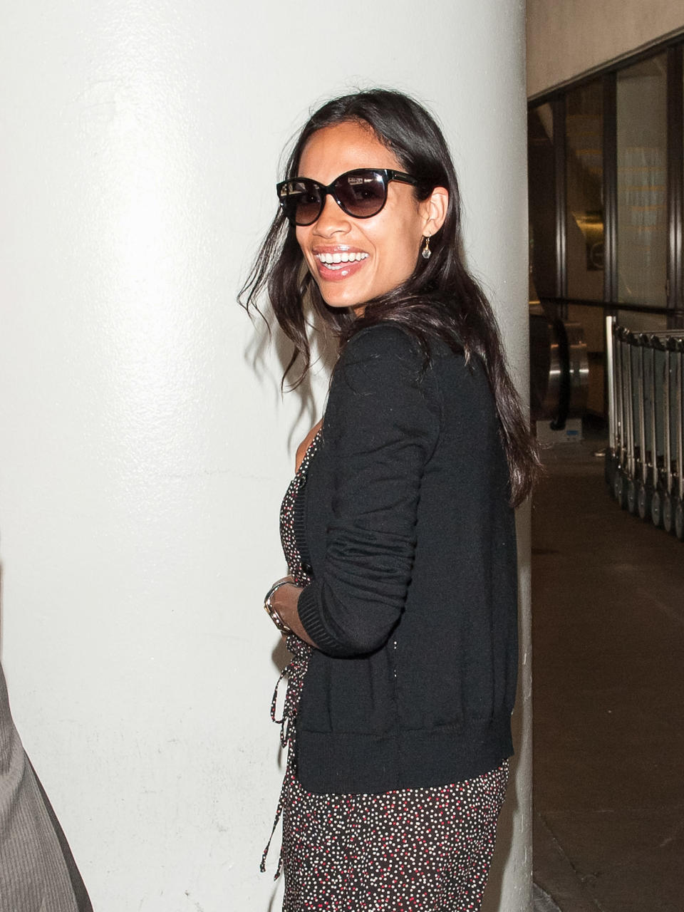 Dawson smiles over her shoulder at the airport