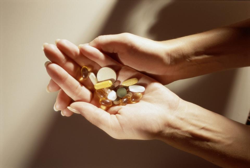 woman holding vitamins