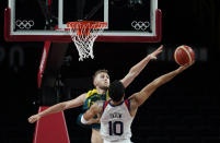 United States's Jayson Tatum (10) shoots around Australia's Jock Landale (13) during men's basketball semifinal game at the 2020 Summer Olympics, Thursday, Aug. 5, 2021, in Saitama, Japan. (AP Photo/Charlie Neibergall)