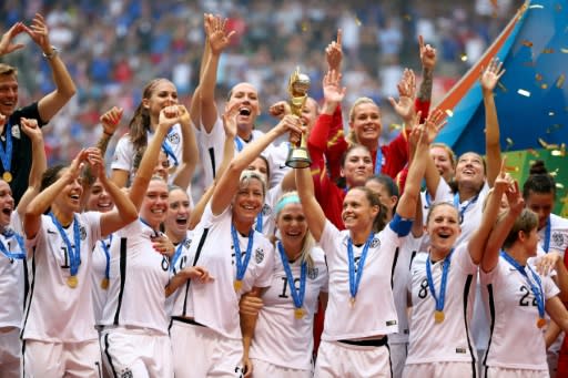 USA players hold aloft the World Cup trophy after winning the 2015 tournament in Canada