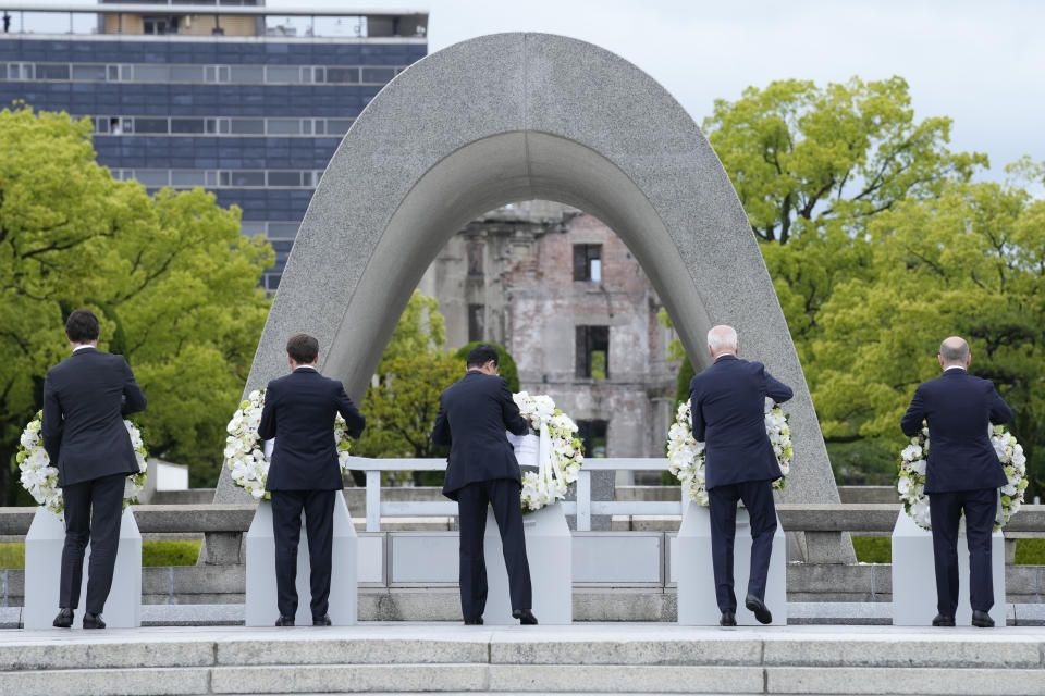 Members of the G7, including from left, Canada's Prime Minister Justin Trudeau, French President Emmanuel Macron, Japan's Prime Minister Fumio Kishida, President Joe Biden and German Chancellor Olaf Scholz, place wreaths at the Hiroshima Peace Memorial Park in Hiroshima, Japan, Friday, May 19, 2023, during the G7 Summit. (AP Photo/Susan Walsh, POOL)