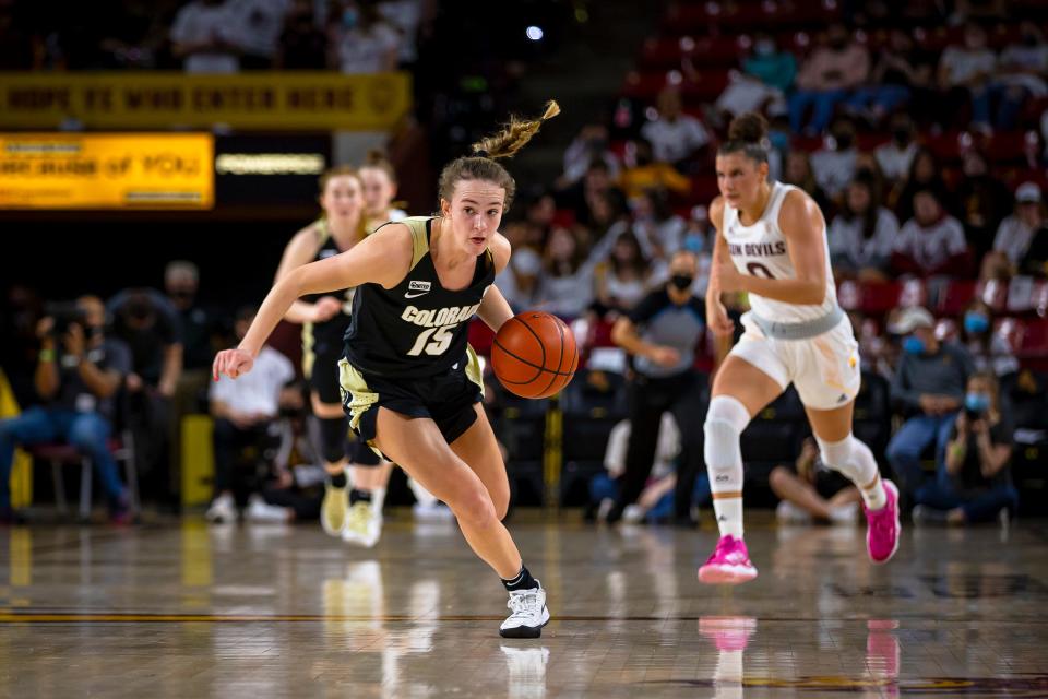 Colorado’s Kindyll Wetta runs with the ball as ASU’s Taya Hanson runs behind her during a game at Desert Financial Arena in Tempe on Jan. 21, 2022. Monica D. Spencer/The Republic 6575576001