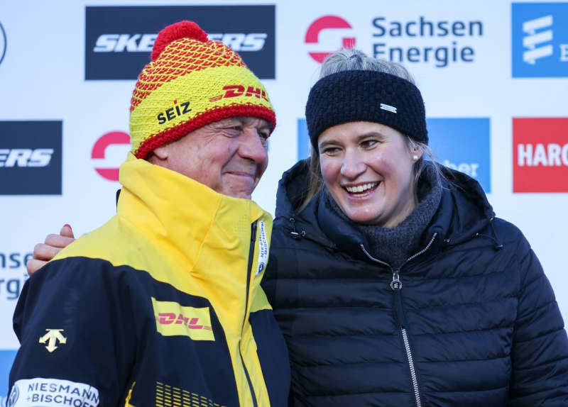 Norbert Loch, German national luge coach, stands next to Natalie Geisenberger at her farewell ceremony. The most successful German Winter Olympic athlete has ended her career and was given a ceremonial farewell on the same day. Jan Woitas/dpa