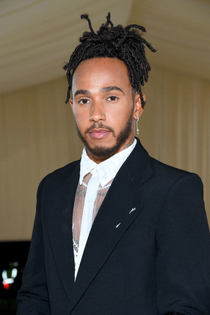 The Met Gala veteran and British racing driver was the picture of elegance with his singular cross earring and nose piercing. What's more, the fashion icon used his seat at the table to support emerging Black designers and creatives. 