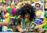 <p>Brazil fans celebrate after the match REUTERS/Carlos Garcia Rawlins </p>