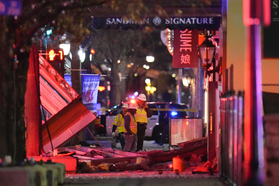 FILE - Workers survey damage near the Sandman Signature hotel following an explosion, Monday, Jan. 8, 2024, in Fort Worth, Texas. On Friday, Jan. 11, The Associated Press reported on stories circulating online incorrectly claiming a 44-year-old migrant was identified as the suspect of an explosion at the historic hotel in Fort Worth. (AP Photo/Julio Cortez)