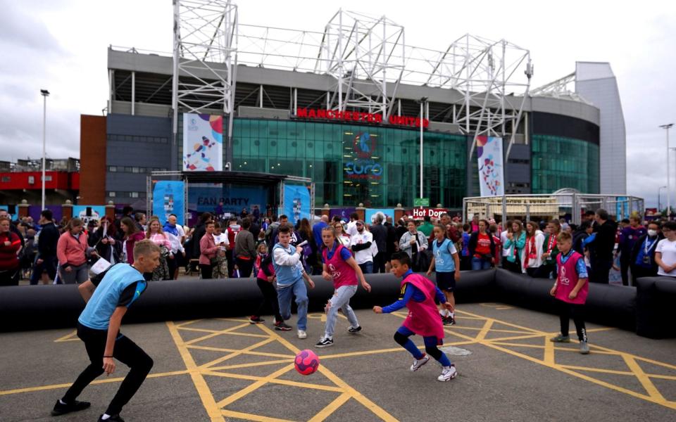 Children play football outside of the stadium ahead of the UEFA Women's Euro 2022 Group A match at Old Trafford, Manchester. Picture date: Wednesday July 6, 2022. PA Photo. See PA story SOCCER England Women - Nick Potts/PA