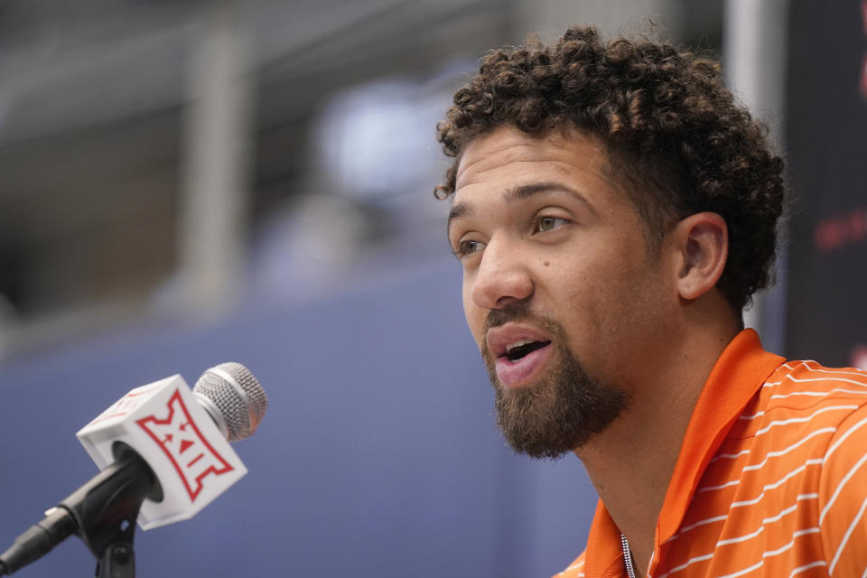Oklahoma State quarterback Spencer Sanders speaks to reporters during the NCAA college football Big 12 media days in Arlington, Texas, Wednesday, July 13, 2022. (AP Photo/LM Otero)