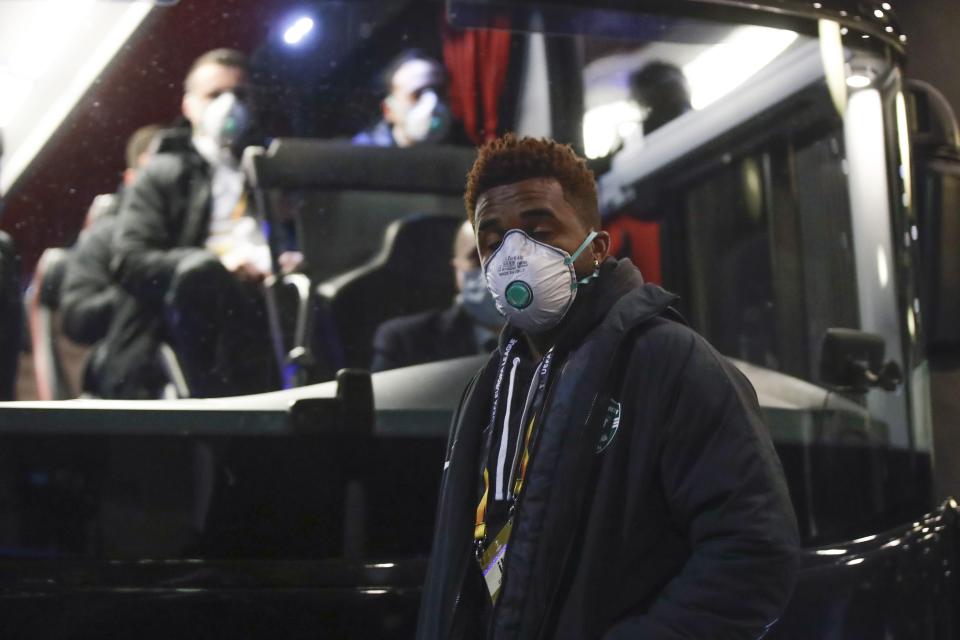 Bulgarian soccer team Ludogorets' Neuciano Gusmao, foregorund, and teammates wearing protective face masks get on a coach bus heading to the San Siro stadium in Milan, Italy, Thursday, Feb. 27, 2020. Ludogorets is playing Italian club Inter Milan in a Europa League soccer match on Thursday that is scheduled to go ahead in an empty stadium due to the coronavirus outbreak. (AP Photo/Luca Bruno)