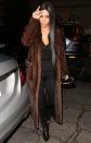 <p>In a floor-length mink coat, black top, black track pants, and lace-up booties while out to dinner with Kanye West in Los Angeles</p>